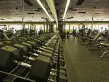 Strength training floor at Bee Fit North Cincinnati with racks, benches and free weights